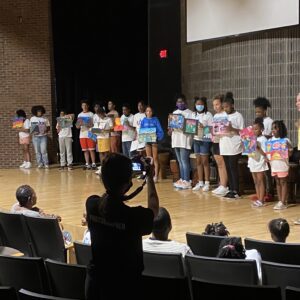 A group of people standing in front of a stage.