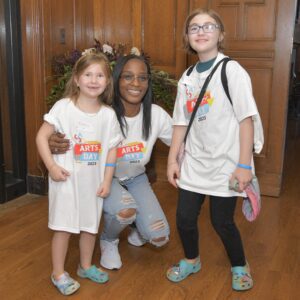 Two small girls and a lady together posing for a photo